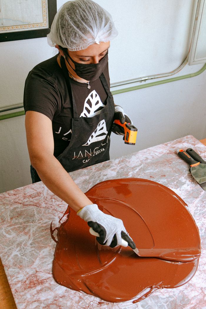 services-02 Artisan woman crafting chocolate in a workshop in Chiapas, Mexico.
